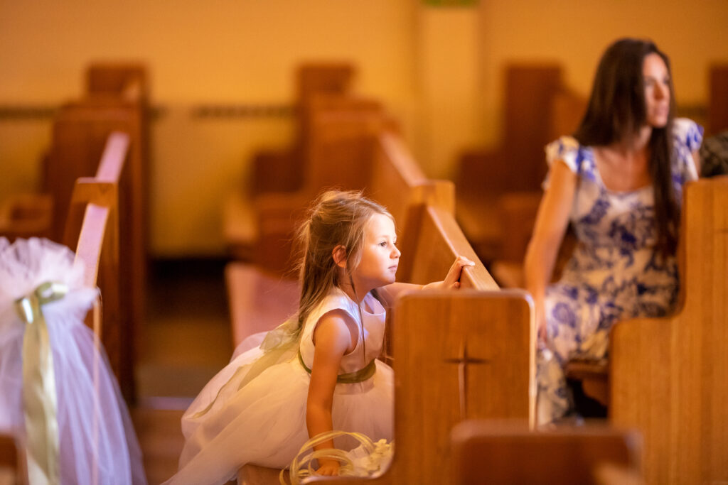 The flower girl waits for the arrival of the bride. As I consider myself a wedding photojournalist, I always strive to find such moments.