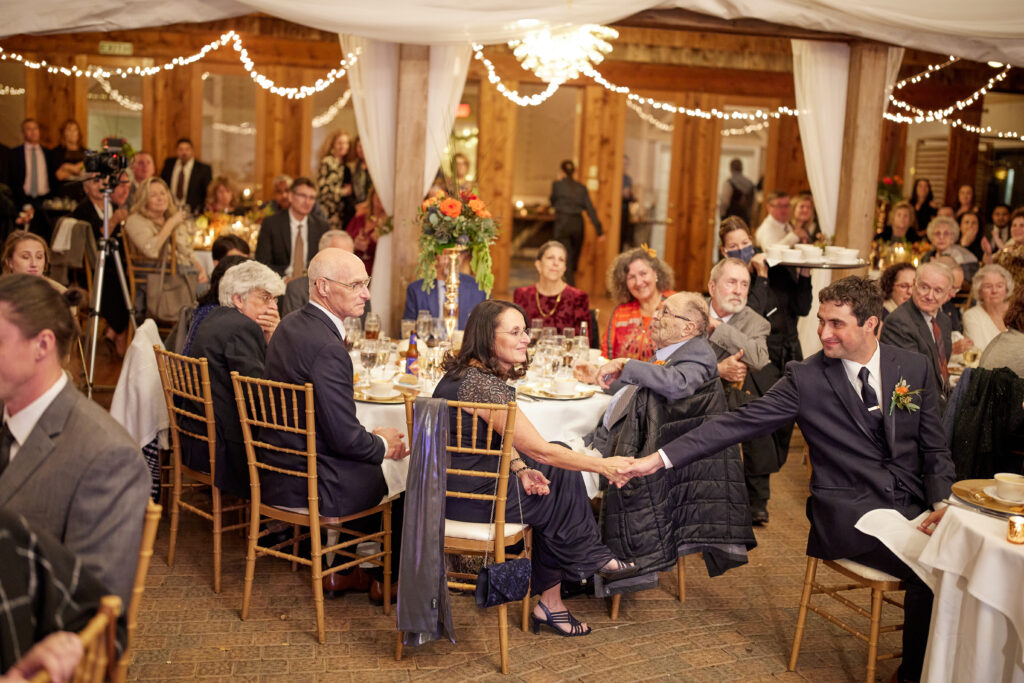 A nice gesture between the groom and his mother during the speeches.