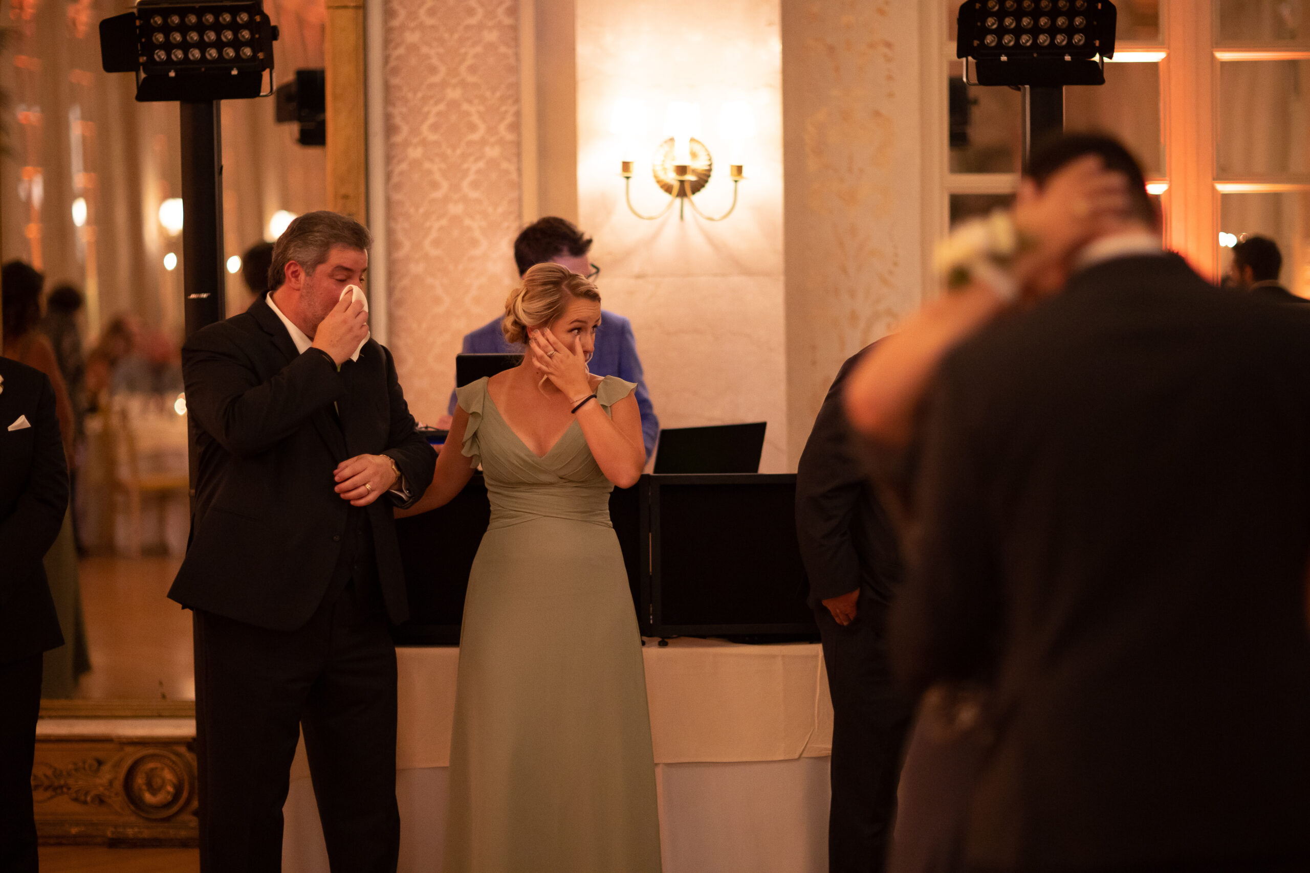 The father and the sister of the groom react emotionally during the mother son dance.