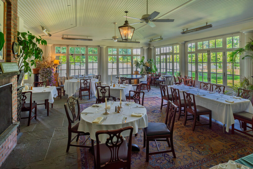 Elegant dining room with panoramic garden views at Mashomack in Pine Plains, New York