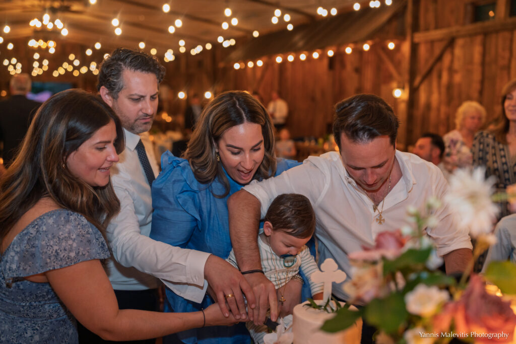 Family members gather around a young child during the christening reception.