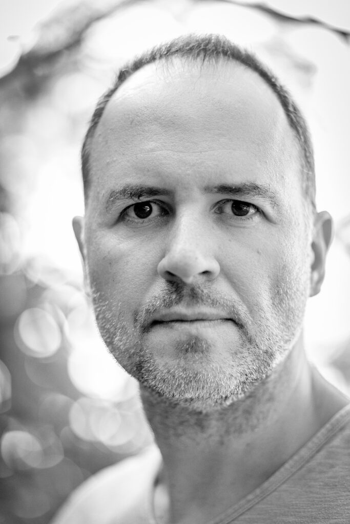 Black-and-white portrait of photographer Yannis Malevitis.