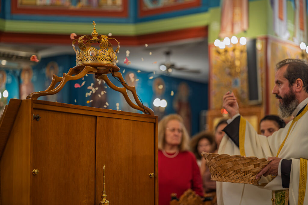 A priest holds a basket of flower petals during the Engomia service.